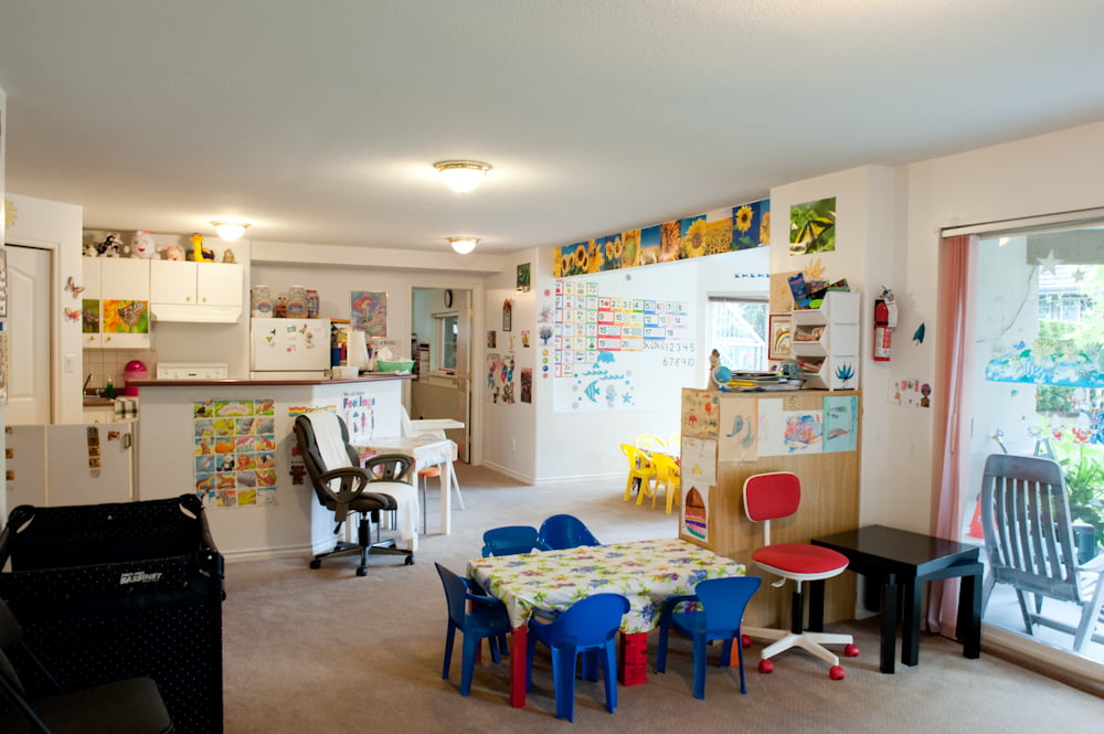 Craft tables and little chairs by a bright window