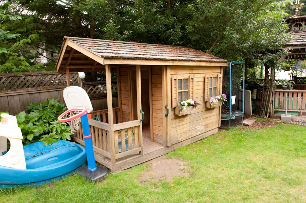 The wooden playhouse and paddling pool